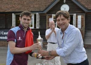 Dylan Budge (Woodhouse Grove) receives the trophy from John Barclay