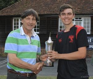 Johnny Barclay of Arundel Castle Cricket Club presents the trophy to Joseph Ludlow, the victorious captain of Hurstpierpoint, after the final of the National Schools Twenty20 competition 2015 between Hurstpierpoint and Malvern College at Arundel Castle Cricket Club, Arundel, West Sussex, England on 3 July 2015. Photo by Sarah Ansell.